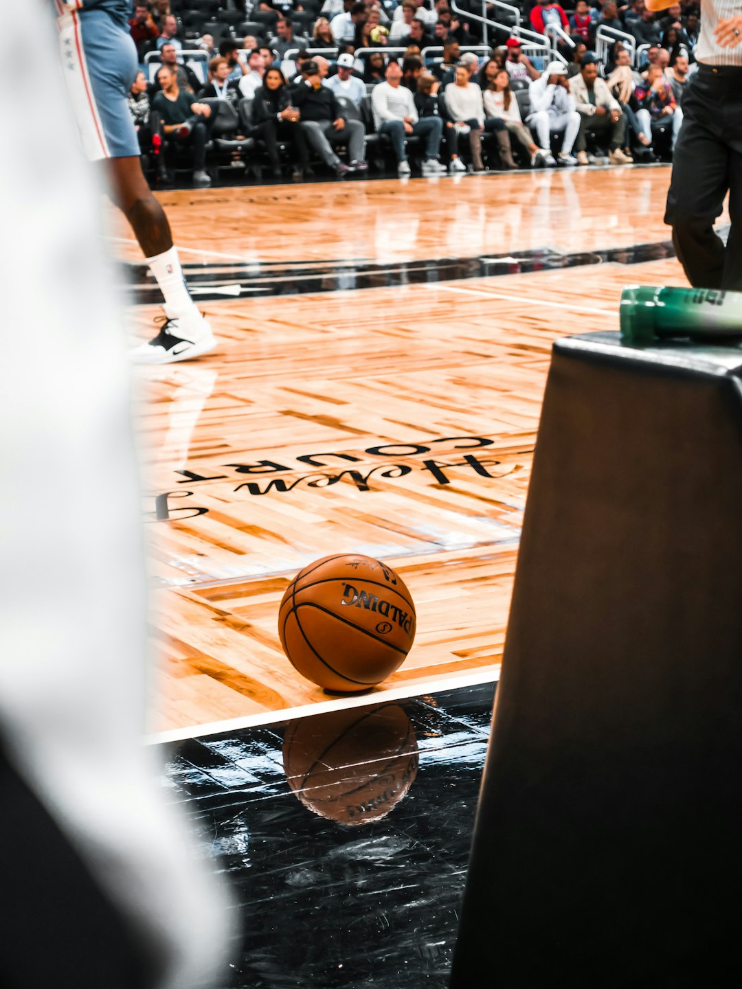 Basketball on a polished court during a game.